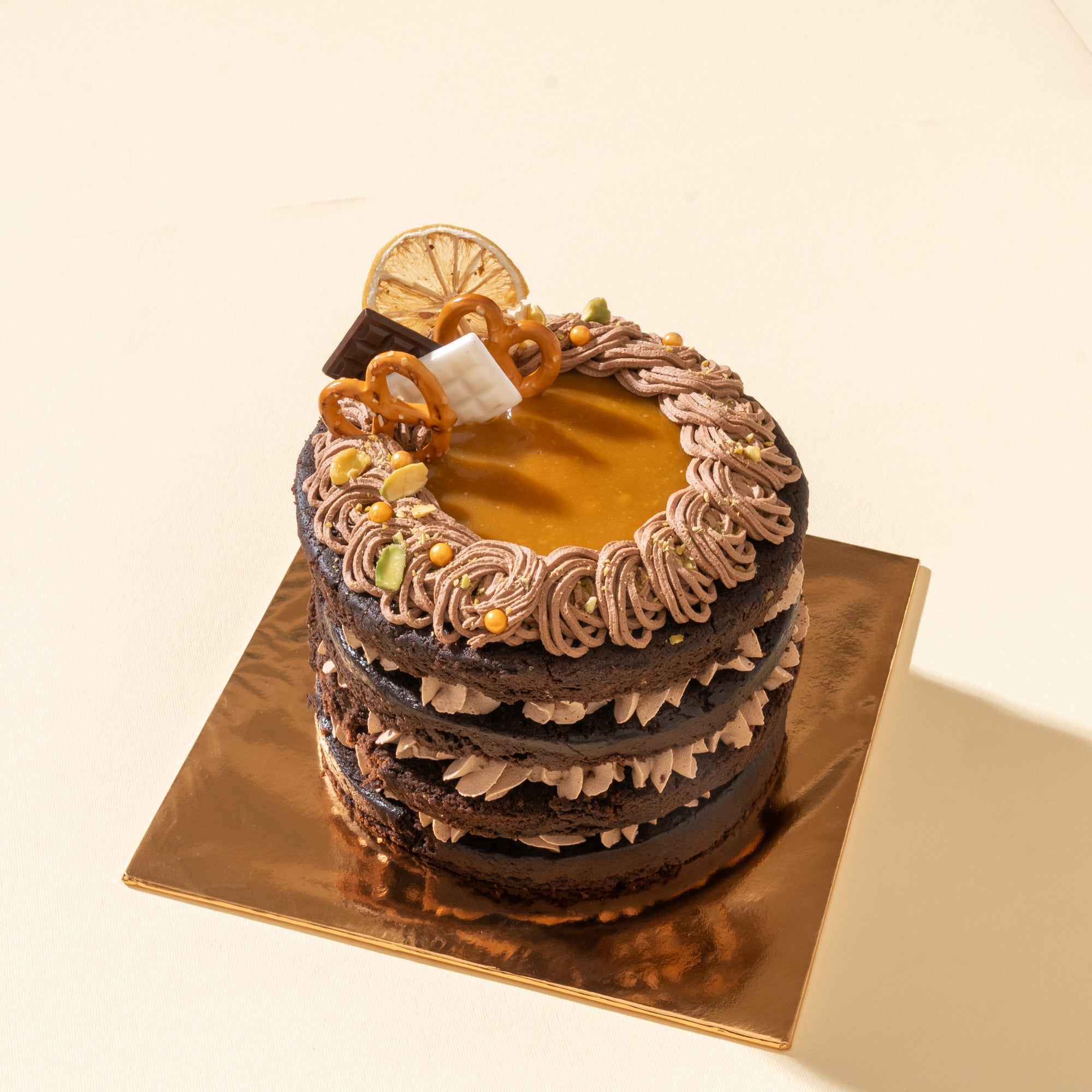 Caramel Vegan Naked Cake with fluffy chocolate sponge layers, vegan caramel frosting, and a rich caramel drizzle, beautifully presented as a dairy-free indulgent treat.