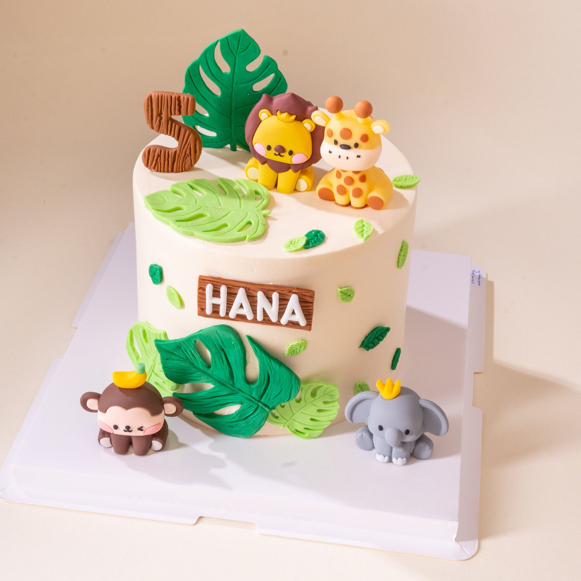 Custom animal-themed birthday cake featuring jungle animals